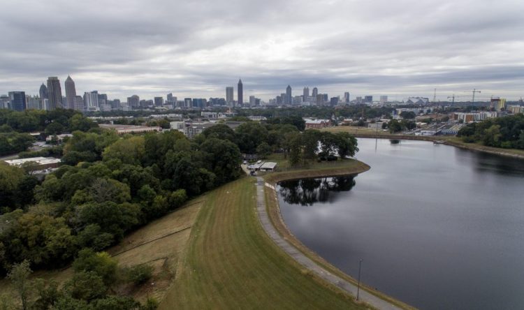 Reservoir No. 1, a 180 million-gallon water supply that has been out of service much of the past few decades, sits against the backdrop of the city skyline Oct. 15 in Atlanta. The city made repairs and brought it back online in 2017, only to shut it down again after water leaks were noticed near businesses located beneath the dam. Were the dam to catastrophically fail, the water could inundate more than 1,000 single-family homes, dozens of businesses, a railroad and a portion of Interstate 75, according to an emergency action plan. 
