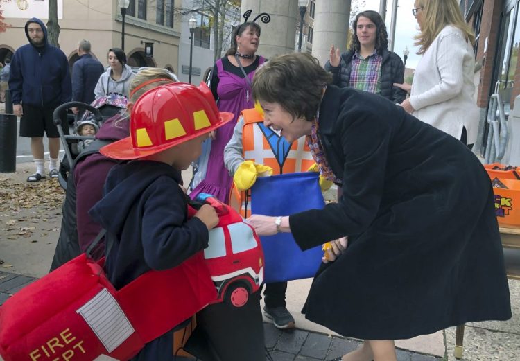 Sen. Susan Collins, R-Maine, hands out candy to children outside her office during an Oct. 25 trick-or-treat event hosted by the local chamber of commerce in Lewiston. Associated Press/David Sharp