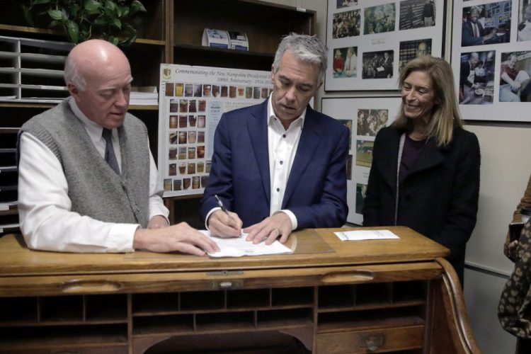 Republican presidential candidate former U.S. Rep. Joe Walsh, R-Ill., files to have his name listed on the New Hampshire primary ballot, Thursday, Nov. 14, 2019, in Concord, N.H. At left is New Hampshire Secretary of State Bill Gardner and at right is his wife Helene Walsh. 