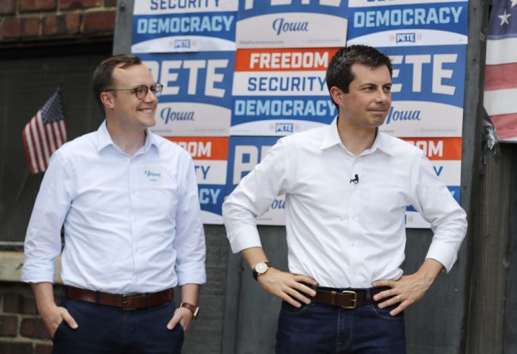 Then-Democratic presidential candidate Pete Buttigieg stands with his husband Chasten, left, before speaking at the Carroll County Democrats Fourth of July Barbecue in Carroll, Iowa, on July 4, 2019. 