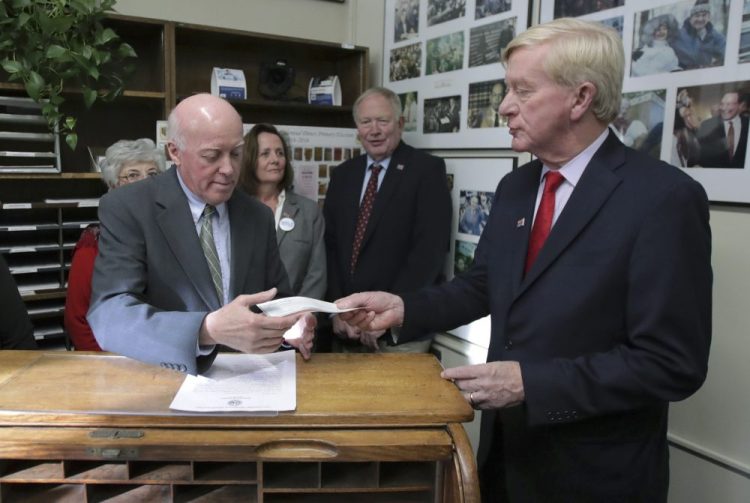 Republican presidential candidate former Massachusetts Gov. William Weld, right, hands paperwork to Secretary of State Bill Gardner as he files to have his name listed on the New Hampshire primary ballot on Wednesday.
