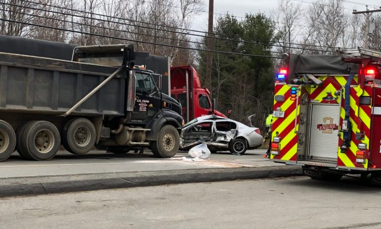 Emergency crews respond Monday morning to a crash between a dump truck and sedan on Riverside Drive in Augusta. 