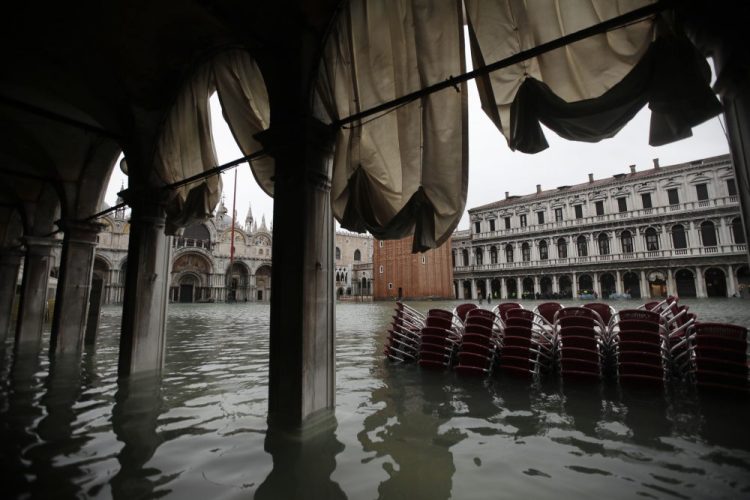 Chairs are piled up in the water in a flooded St. Mark's Square in Venice, Italy, Friday.
