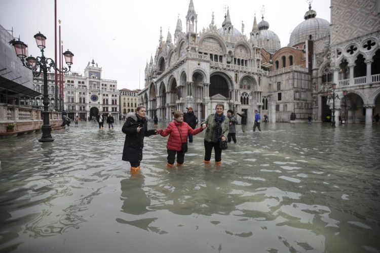 People wade through water in a flooded St. Mark's Square in Venice on Wednesday.