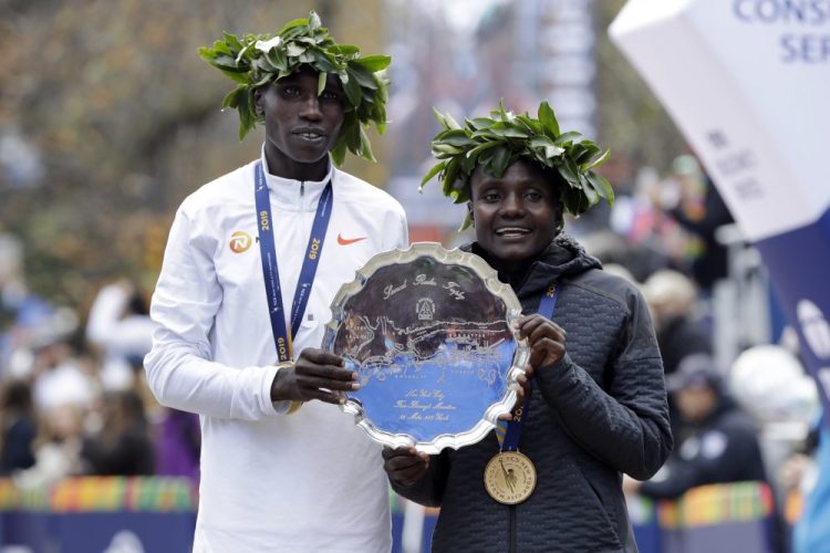 Geoffrey Kamworor, left, and Joyciline Jepkosgei, both of Kenya, pose as the men's and women's winners of the New York City Marathon on Sunday  in New York's Central Park.