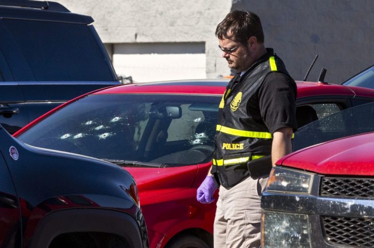 A member of the Oklahoma State Bureau of Investigation works the scene of a double-murder suicide in the parking lot of a Walmart in Duncan, Okla., on Monday. 