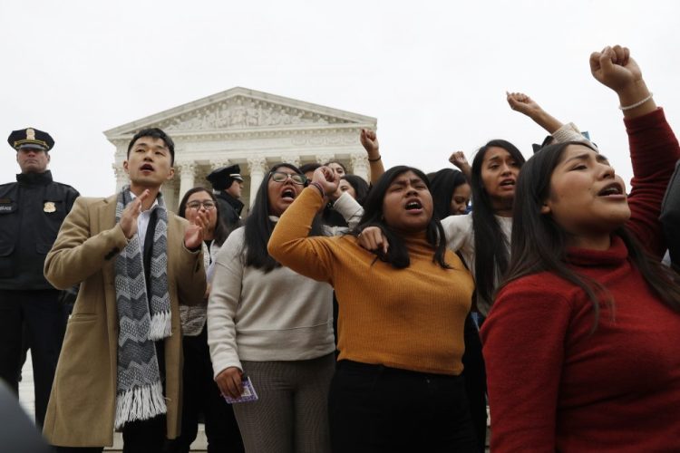 DACA recipients and others leave the U.S. Supreme Court with their hands in the air after oral arguments were heard in the case of President Trump's decision to end the Obama-era Deferred Action for Childhood Arrivals program on Tuesday at the Supreme Court in Washington. 