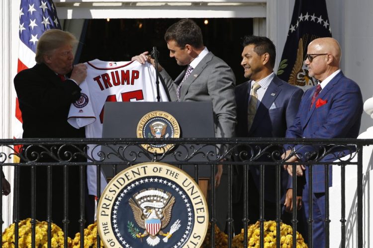 Nationals first baseman Ryan Zimmerman, center, presents a jersey to President Trump at the White House on Monday. Standing alongside Zimmerman are manager Dave Martinez, second from right, and General Manager Mike Rizzo.