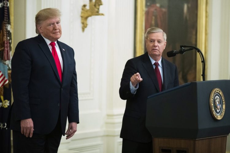 President Trump listens to Sen. Lindsey Graham, R-S.C., speak Nov. 6 during a ceremony in the East Room of the White House in Washington.