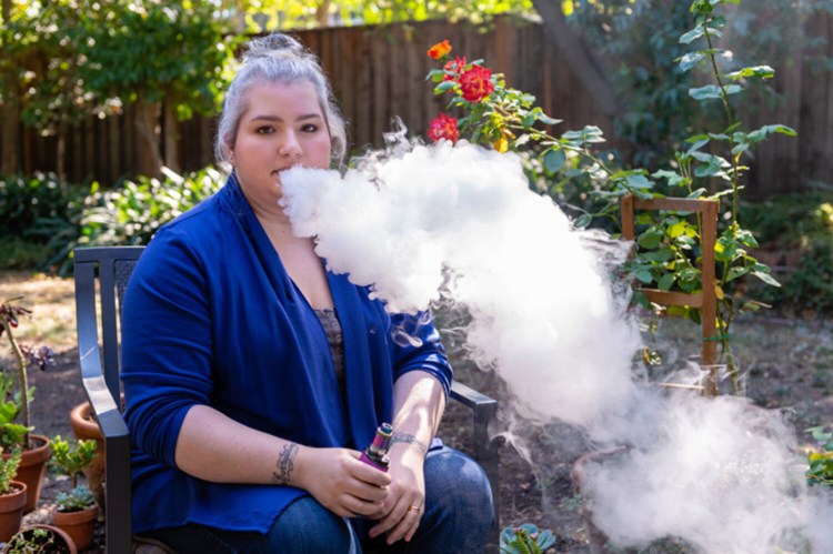 Danielle Jones takes a deep hit and great clouds of vapor billow out of her nose and mouth. Jones said she has no plans to stop vaping, despite warnings from the Centers for Disease Control and Prevention and mounting evidence that vaping may have serious health risks. (Heidi de Marco/KHN/TNS)