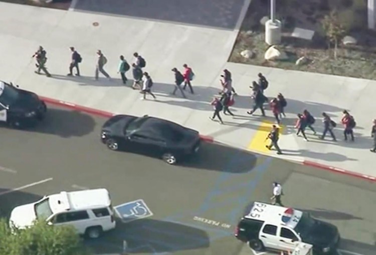 People are lead out of Saugus High School after  a shooting on Thursday morning in Santa Clarita, Calif.  
