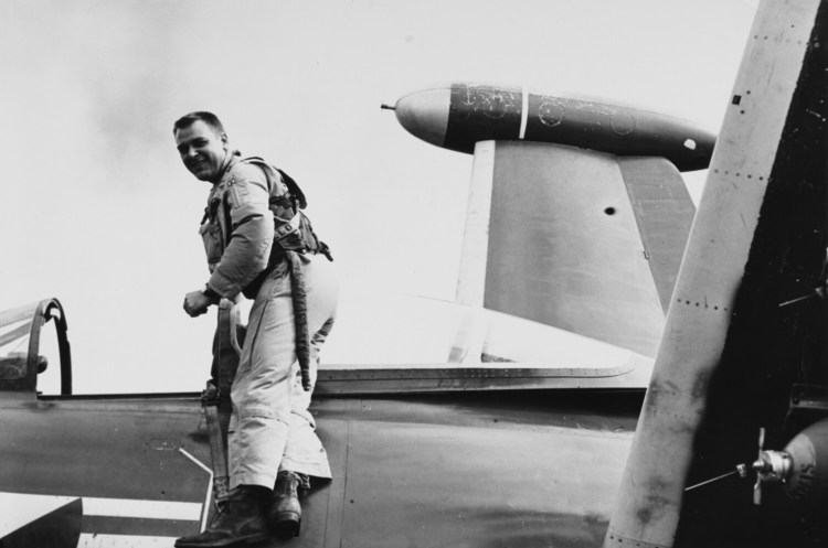 James Holloway stands on a F9F Panther jet fighter in 1953.