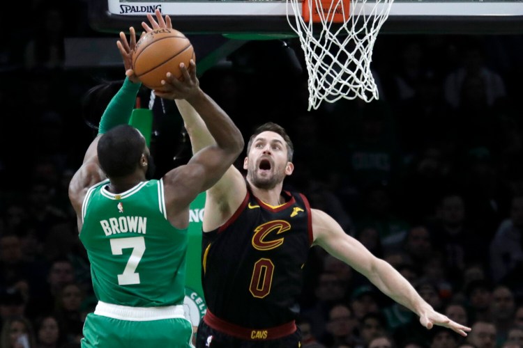 Celtics guard Jaylen Brown shoots against Cavaliers forward Kevin Love during the Celtics’ 129-11-7 win on Friday in Boston. Brown finished with 34 points and nine rebounds.