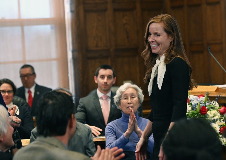 Portland Mayor Kate Snyder looks toward her family after being sworn in at Portland City Hall on Monday.