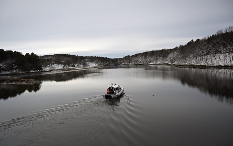 A dive team on a Maine Marine Patrol boat makes its way up the Presumpscot River in Falmouth on Wednesday as the search continued for Anneliese Heinig, 37, who disappeared after she left her car on Interstate 295. 