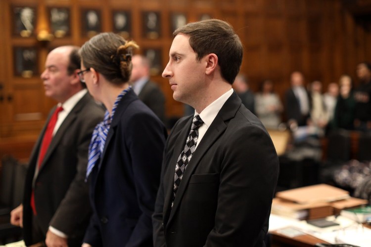 Mark Cardilli Jr. stands with his attorneys Monday as Justice Nancy Mills leaves the courtroom on the first day of his trial at the Cumberland County Courthouse. Cardilli is charged with murder in the death of Isahak Muse, who was Cardilli's younger sister's boyfriend.