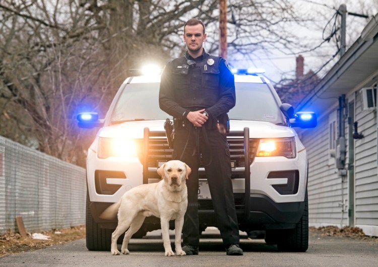 Jimmy Leathers poses for a portrait Friday with his new K-9 companion, Wrex, outside the Clinton Police Department.