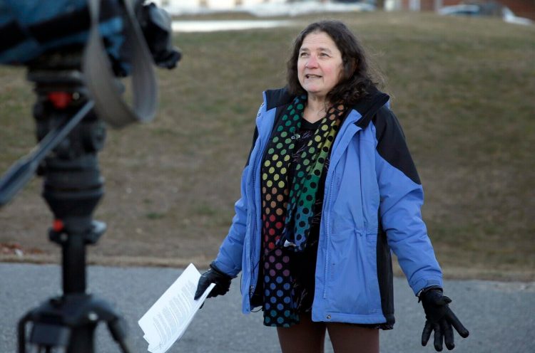 Janet Kuech, a longtime ed tech at Narragansett Elementary School in Gorham, speaks to reporters outside the school Monday. Kuech was elected to the Gorham Town Council in November but her seat has been blocked by councilors who say her job as a public school employee is a conflict of interest.