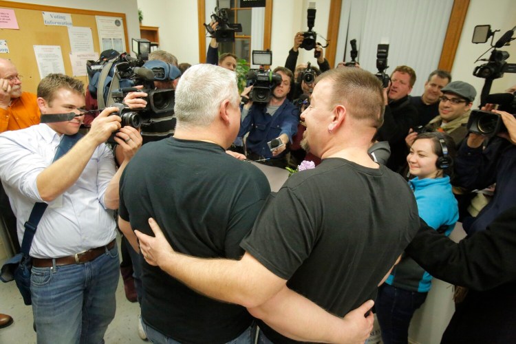 A crowd of photographers wait to take photos of Michael Snell, left, and Steven Bridges at Portland City Hall on Saturday, December 29, 2012, as they became the first same-sex couple to wed in Maine.  