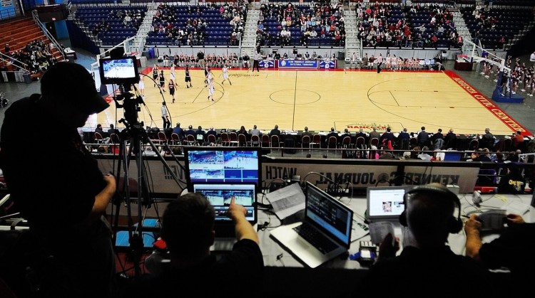 Working high above center court, the Munzing Media team covers an Eastern Class A tournament game between Skowhegan and Bangor on Feb. 15, 2013, at the Augusta Civic Center. 