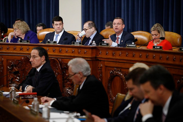 House Judiciary Committee ranking member Doug Collins, R-Ga., right, gives his opening statement during Wednesday night's committee markup of the articles of impeachment against President Trump. Committee Chairman Jerrold Nadler, D-N.Y., is at left.
