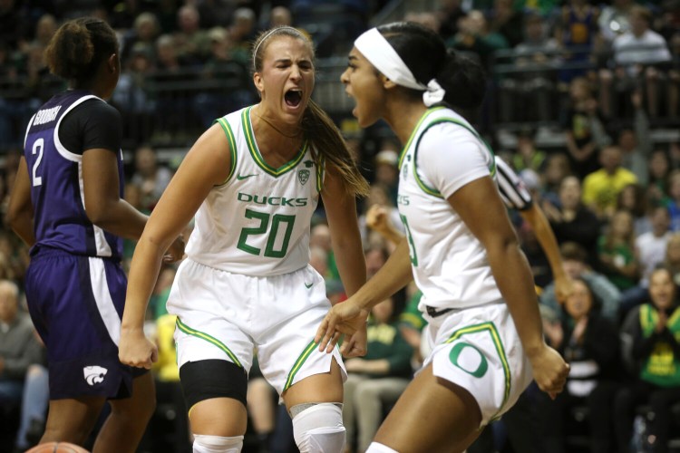 Oregon's Sabrina Ionescu, center, and Minyon Moore celebrate during the Ducks' 89-51 win over Kansas State on Saturday in Eugene, Oregon.