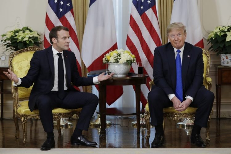 President Trump meets French President Emmanuel Macron at Winfield House on Tuesday in London. The French government fired back against the Trump administration, insisting the European Union would retaliate if the White House went through with its tariff proposal.