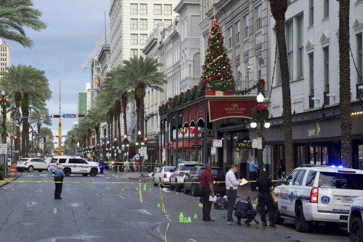 New Orleans police investigate the scene of a shooting Sunday on the edge of the city's famed French Quarter. 