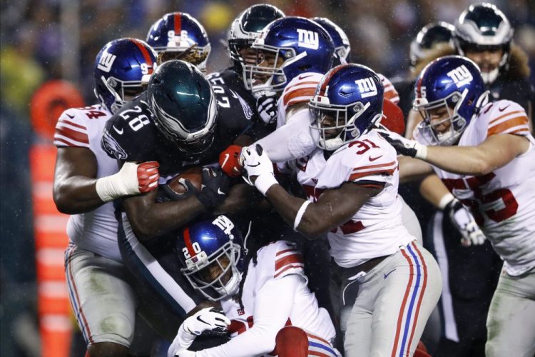 Philadelphia's Jay Ajayi (28) is tackled by the New York Giants.