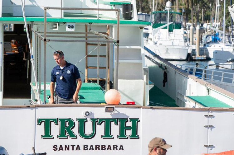 FBI agents search the Truth dive boat, a sister vessel to the Conception, as authorities issue a search warrant for the Truth Aquatics' offices on the Santa Barbara Harbor in Santa Barbara, Calif., in September. Thirty-four people died when the Conception burned and sank before dawn on Sept. 2. They were sleeping in a cramped bunk room below the main deck and their escape routes were blocked by fire. 