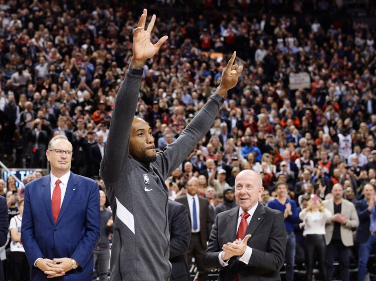 Kawhi Leonard, the former Toronto Raptor now with the Los Angeles Clippers, forward  salutes the crowd as he receives his 2019 NBA championship ring prior to Wednesday's game in Toronto. 