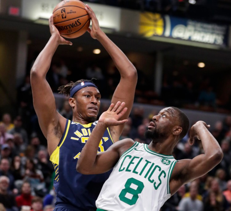 Indiana’s Myles Turner grabs a rebound over Boston’s Kemba Walker during Wednesday’s game in Indianapolis.