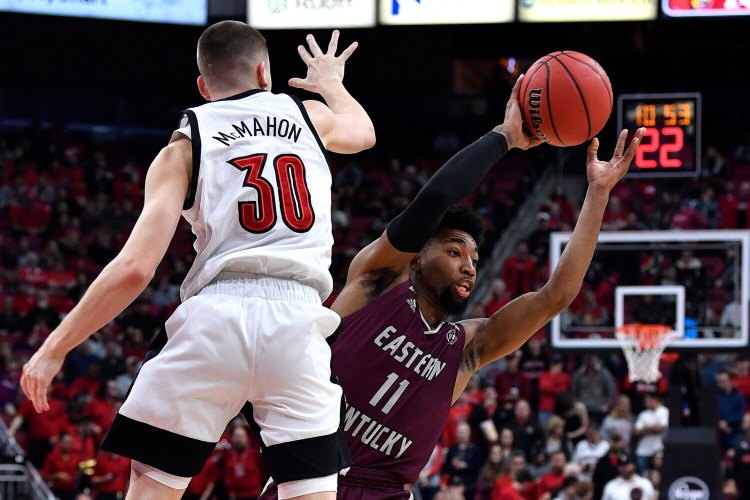 Eastern Kentucky guard Jomaru Brown tries to make a pass while being guarded by Louisville's Ryan McMahon during the Cardinals' 99-67 win Saturday in Louisville, Kentucky.