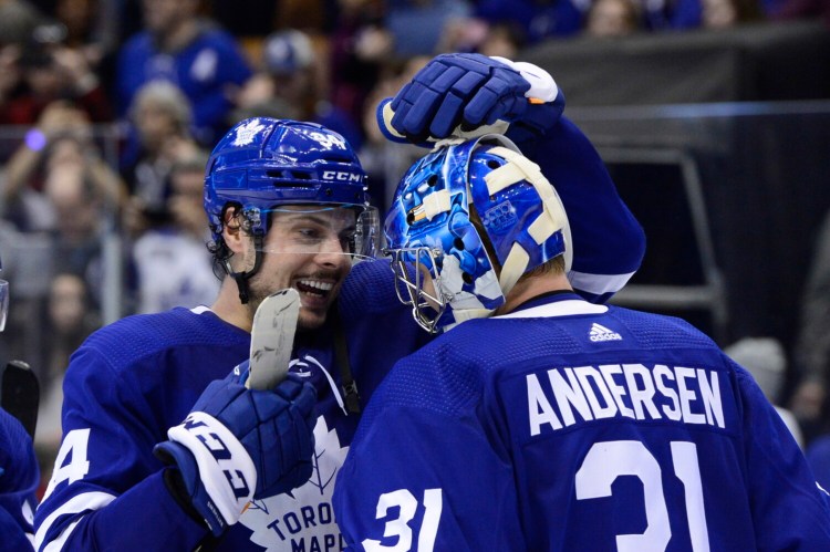 Toronto Maple Leafs centre Auston Matthews congratulates goaltender Frederik Andersen the Maple Leafs rallied to beat the Carolina Hurricanes 8-6 on Monday in Toronto.