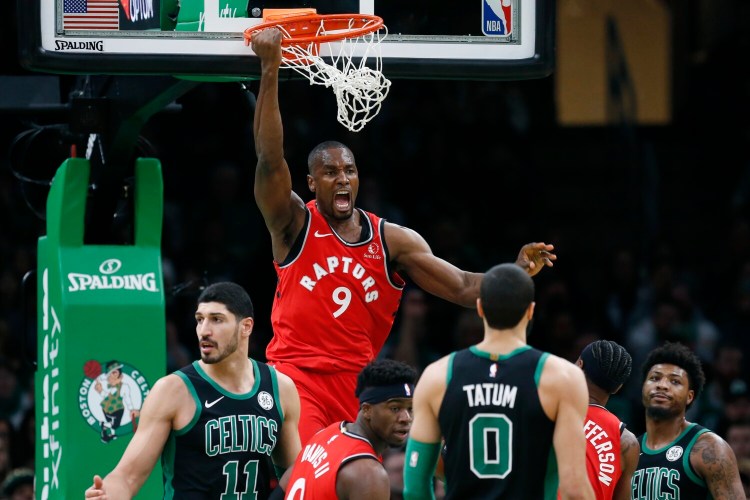 Toronto's Serge Ibaka celebrates after his dunk during the Raptors' 113-97 win over the Celtics on Saturday in Boston.