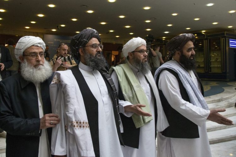 Mullah Abdul Ghani Baradar, the Taliban group's top political leader, second left, arrives with other members of the Taliban delegation for talks in Moscow, Russia., in May. On Saturday, U.S. peace envoy Zalmay Khalilzad met with Afghanistan's Taliban since last September when President Trump declared a near-certain peace deal with the insurgents dead. 