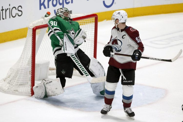 Dallas Stars goaltender Ben Bishop makes a save off his head as Colorado Avalanche left wing Gabriel Landeskog watches during the second period Saturday in Dallas.