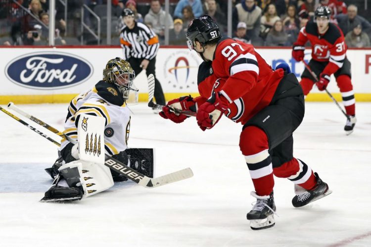 Boston Bruins goaltender Jaroslav Halak blocks a shot by New Jersey Devils left wing Nikita Gusev during the Devils' 3-2 win in a shootout on Tuesday in Newark, N.J.