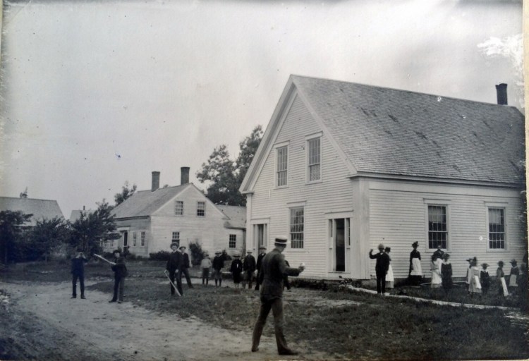 In this early 1800 photo, teacher Charles Besse plays ball with students at the original Jefferson Village School. Notice that the bats are boards and there are no gloves to be seen. The girls, most with hats and aprons, look on. The building still stands in the North Village across from the apartment building which used to be Hoffses and later, Marshall Holmes’s store.