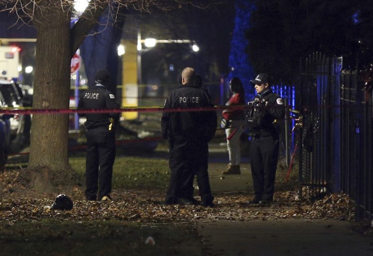 Chicago police guard a crime scene in the 5700 block of South May Street after a shooting Sunday.