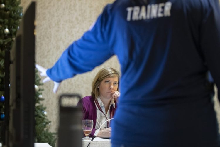 Karen Brenson Bell, of North Carolina, listens during an exercise run by military and national security officials for state and local election officials to simulate different scenarios for the 2020 elections, in Springfield, Va., this month.