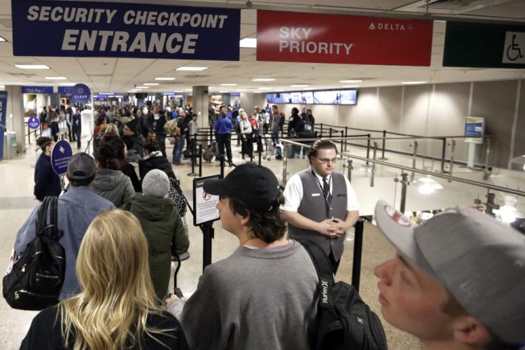Travelers walk through a security checkpoint in Terminal 2 at Salt Lake City International Airport on Nov. 27. Federal officials are considering requiring that all travelers, including American citizens, be photographed as they enter or leave the country as part of an identification system using facial-recognition technology. 