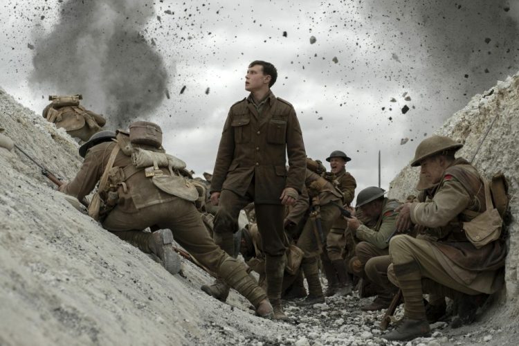 This image released by Universal Pictures shows George MacKay, center, in a scene from "1917," directed by Sam Mendes. 