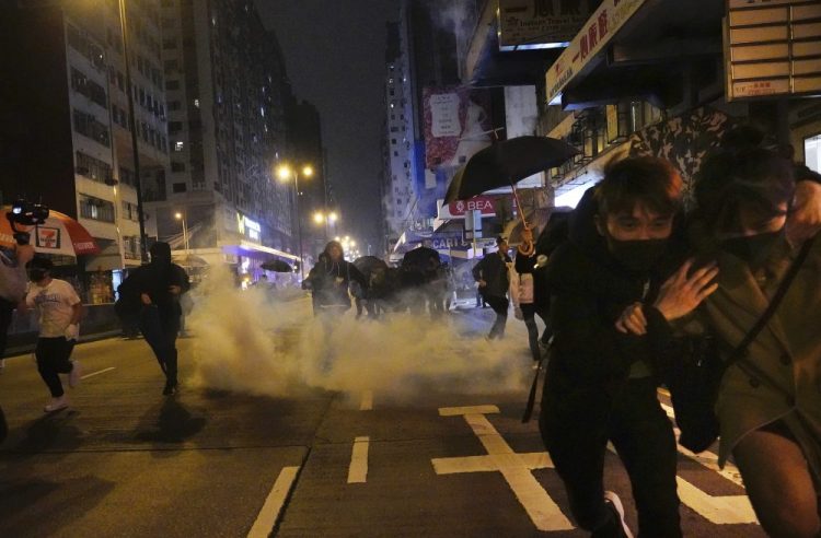 Protesters react as police fire tear gas during a demonstration in Hong Kong early Wednesday. 