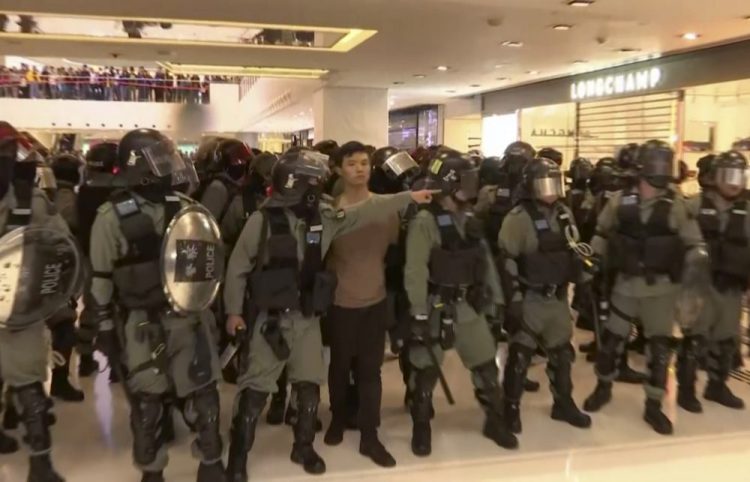 A protester is arrested by police at a shopping mall in Sha Tin district in Hong Kong on Sunday. Riot officers fanned out at the mall where demonstrators spray-painted protest slogans on the polished stone floor and smashed glass panels.