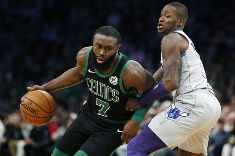 Jaylen Brown, left, was sick Monday and unable to practice with the Celtics. He will miss their game Tuesday against Charlotte.