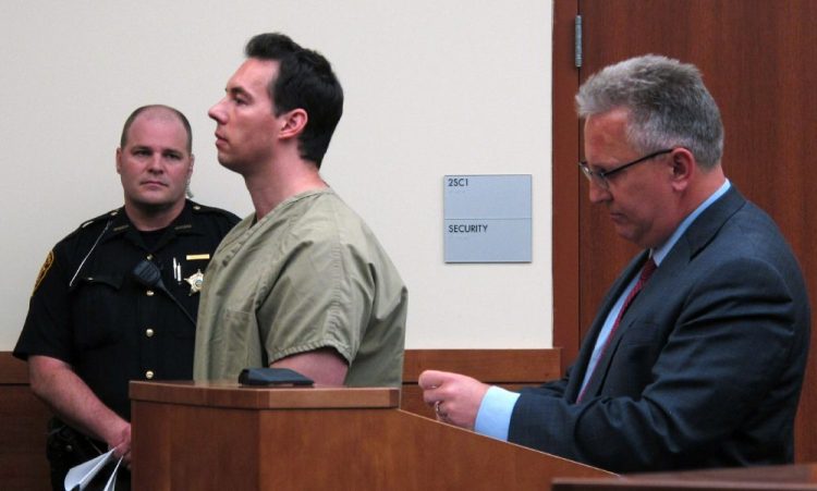 Critical care doctor William Husel, center, pleads not guilty to murder charges while appearing with defense attorney Richard Blake, right, in Franklin County Court in Columbus, Ohio,in June. 