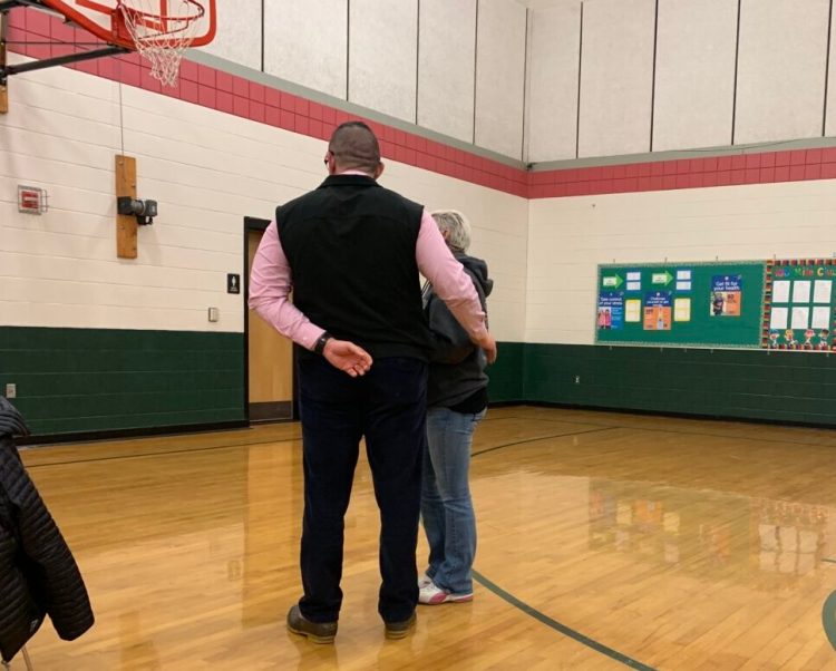 Local resident Leah May is removed from the gymnasium at Carrabec Community School during Regional School Unit 74 board meeting Wednesday night. May shouted at board members during a heated exchange about an investigation regarding a teacher who was recently placed on administrative leave.
