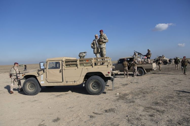 Iraqi army units are deployed during military operations of the Iraqi Army's Seventh Brigade on Sunday in Anbar, Iraq. An Iraqi general said Sunday that security has been beefed up around the Ain al-Asad air base, a sprawling complex in the western Anbar desert that hosts U.S. forces, after a series of attacks.