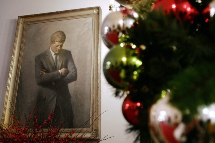 A portrait of former President John F. Kennedy, framed by Christmas decorations, hangs in the White House in Washington. 
